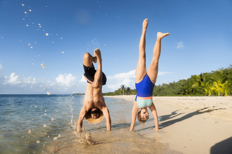 Couple doing a handstand on the beach